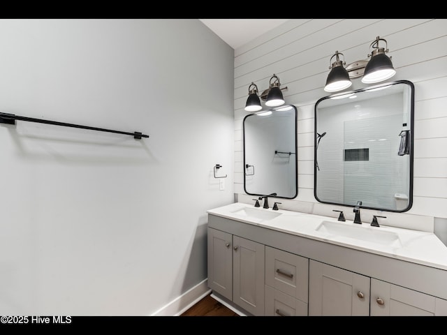 119 NE 27th St, Oak Island, NC 28465 - full bath with a tile shower, double vanity, baseboards, wood finished floors, and wooden walls
