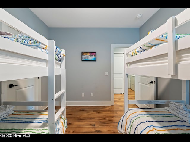 119 NE 27th St, Oak Island, NC 28465 - bedroom featuring wood finished floors and baseboards