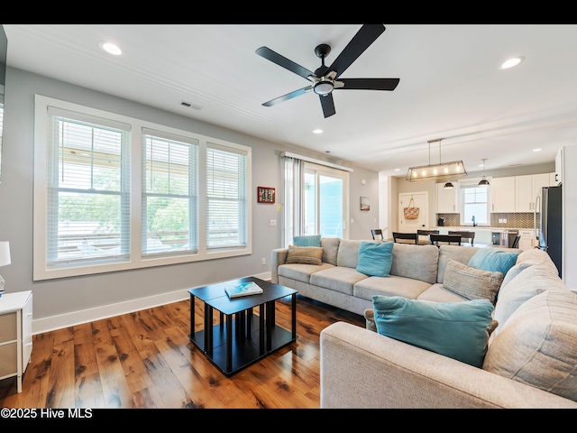 119 NE 27th St, Oak Island, NC 28465 - living room with a ceiling fan, recessed lighting, wood finished floors, and baseboards
