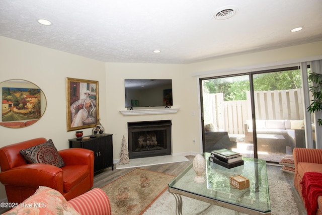940 Linden Rd Unit 19, Pinehurst, NC 28374 - living room featuring wood finished floors, a fireplace, recessed lighting, and baseboards