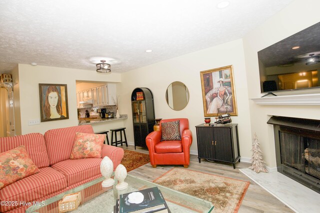 940 Linden Rd Unit 19, Pinehurst, NC 28374 - living room featuring a fireplace, light wood-type flooring, recessed lighting, and baseboards