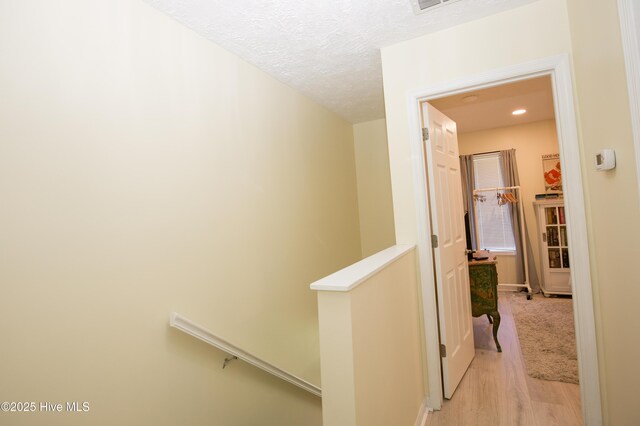 940 Linden Rd Unit 19, Pinehurst, NC 28374 - hall featuring light wood-style floors, an upstairs landing, a textured ceiling, baseboards, and recessed lighting