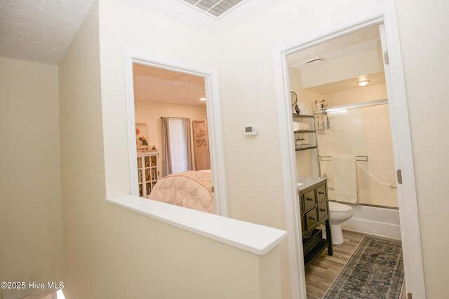 940 Linden Rd Unit 19, Pinehurst, NC 28374 - hallway featuring wood finished floors and attic access