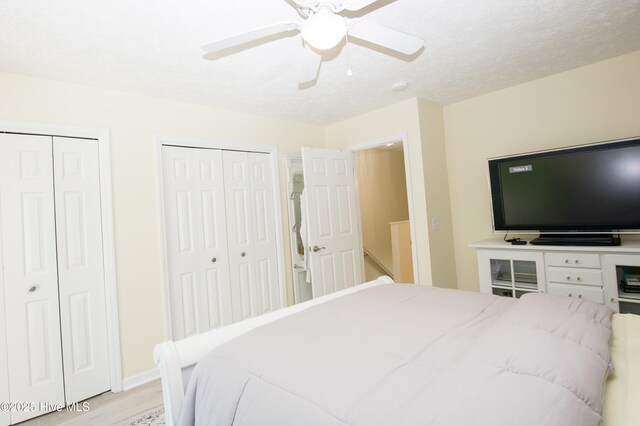 940 Linden Rd Unit 19, Pinehurst, NC 28374 - bedroom featuring two closets, light wood-style flooring, ceiling fan, and baseboards