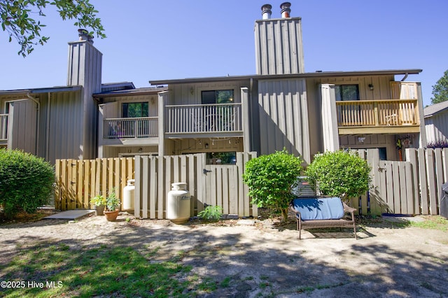 940 Linden Rd Unit 19, Pinehurst, NC 28374 - back of property with a balcony, a chimney, and board and batten siding