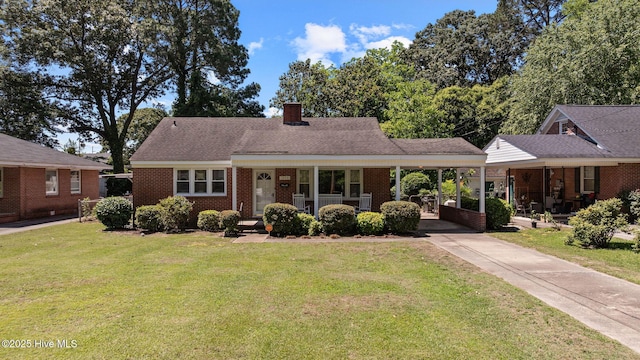 1606 Palm St, Goldsboro, NC 27530 - view of front of home with covered porch, driveway, a front yard, and a carport
