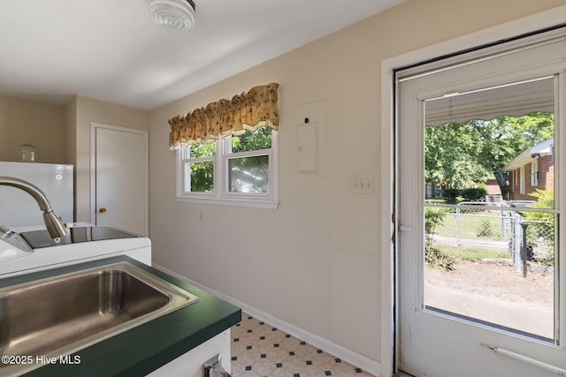 1606 Palm St, Goldsboro, NC 27530 - laundry room with light floors, washer / clothes dryer, baseboards, cabinet space, and water heater