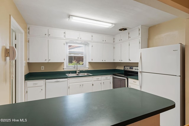 1606 Palm St, Goldsboro, NC 27530 - kitchen with white appliances, a sink, dark countertops, and white cabinetry