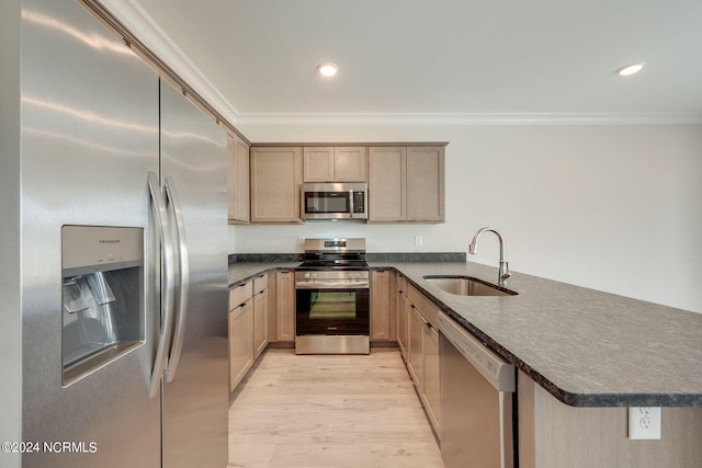 2133 Kali Ln Unit A, Greenville, NC 27834 - kitchen with stainless steel appliances, a sink, a peninsula, dark countertops, and light wood-type flooring