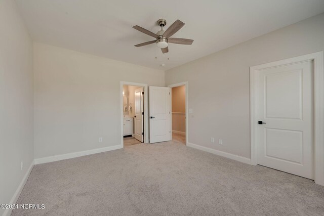 2133 Kali Ln Unit A, Greenville, NC 27834 - unfurnished bedroom featuring light carpet, baseboards, ensuite bath, and a ceiling fan