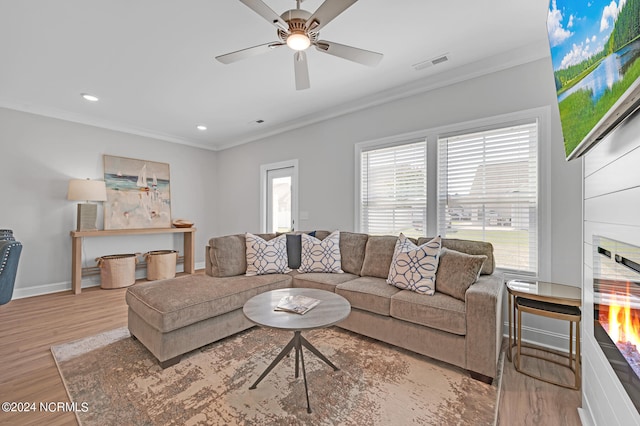 2133 Kali Ln Unit B, Greenville, NC 27834 - living room with ornamental molding, a warm lit fireplace, wood finished floors, baseboards, and ceiling fan