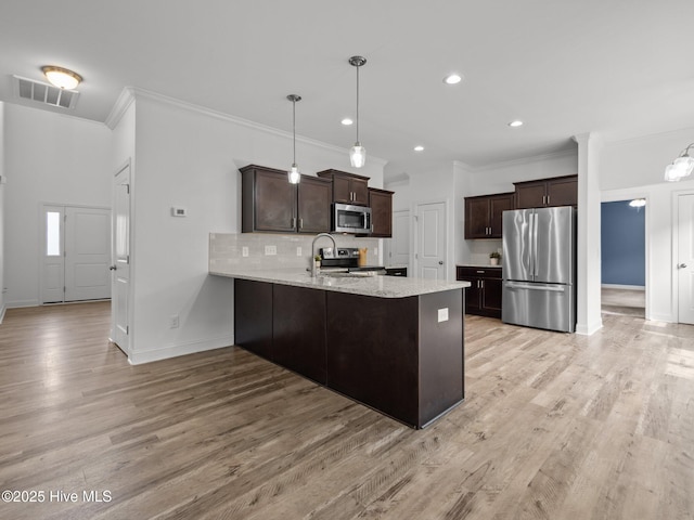 608 Creek Ct, Swansboro, NC 28584 - kitchen featuring stainless steel appliances, crown molding, dark brown cabinetry, baseboards, and a peninsula