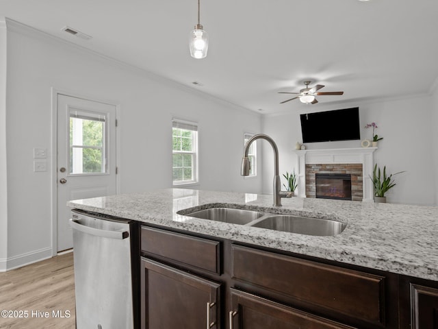 608 Creek Ct, Swansboro, NC 28584 - kitchen featuring dishwasher, a sink, light wood finished floors, dark brown cabinets, and crown molding