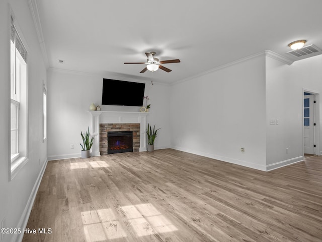 608 Creek Ct, Swansboro, NC 28584 - unfurnished living room featuring ceiling fan, crown molding, light wood finished floors, a fireplace, and baseboards