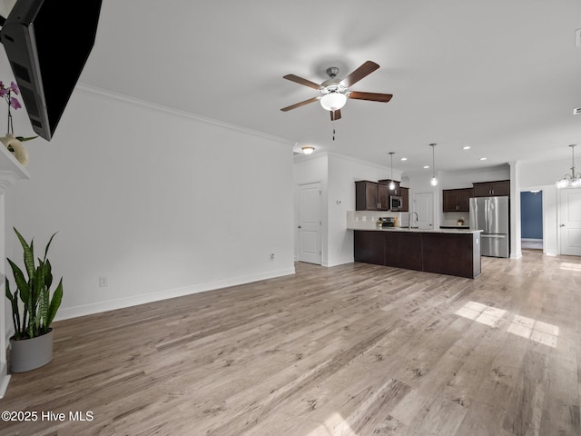 608 Creek Ct, Swansboro, NC 28584 - unfurnished living room featuring a ceiling fan, light wood-type flooring, baseboards, a chandelier, and crown molding