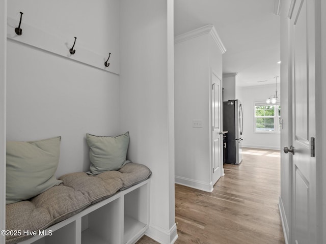 608 Creek Ct, Swansboro, NC 28584 - mudroom with light wood-type flooring, baseboards, and a chandelier
