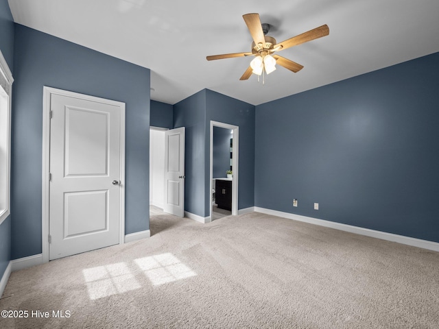 608 Creek Ct, Swansboro, NC 28584 - unfurnished bedroom with carpet flooring, baseboards, ceiling fan, and ensuite bathroom