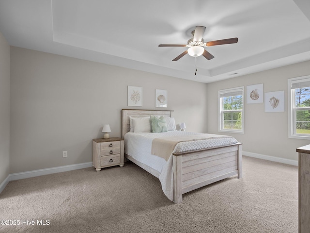 608 Creek Ct, Swansboro, NC 28584 - bedroom with a raised ceiling, carpet floors, baseboards, and a ceiling fan