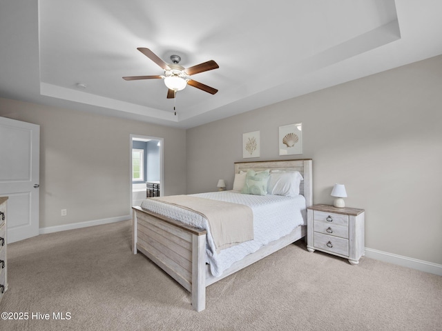 608 Creek Ct, Swansboro, NC 28584 - carpeted bedroom featuring a raised ceiling, baseboards, and a ceiling fan