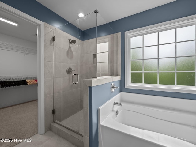 608 Creek Ct, Swansboro, NC 28584 - full bath featuring a stall shower, a walk in closet, a garden tub, and tile patterned flooring
