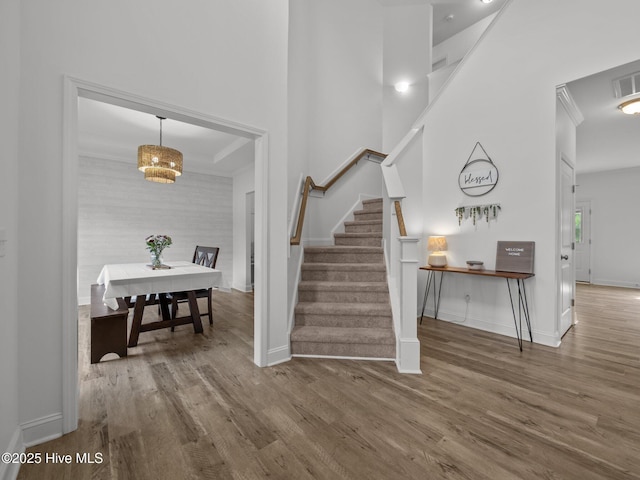 608 Creek Ct, Swansboro, NC 28584 - staircase featuring wood finished floors, baseboards, and crown molding