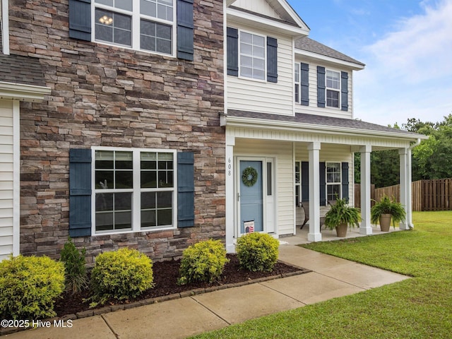 608 Creek Ct, Swansboro, NC 28584 - view of front of house featuring stone siding, covered porch, and a shingled roof