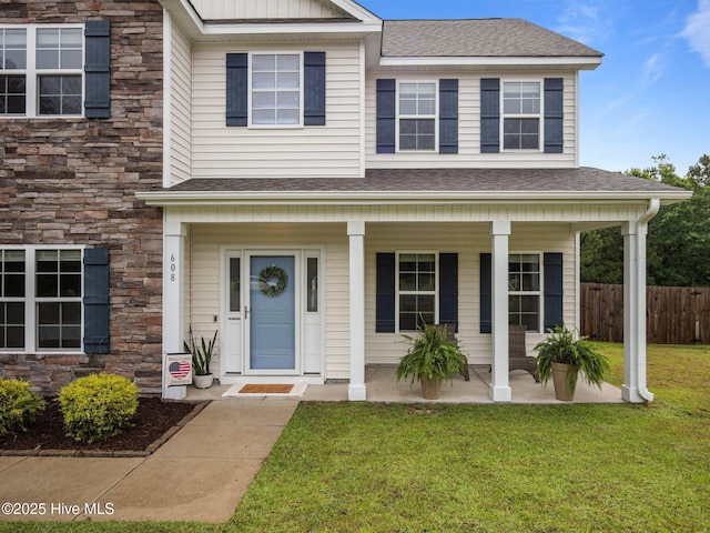 608 Creek Ct, Swansboro, NC 28584 - view of front facade featuring stone siding, a porch, and roof with shingles