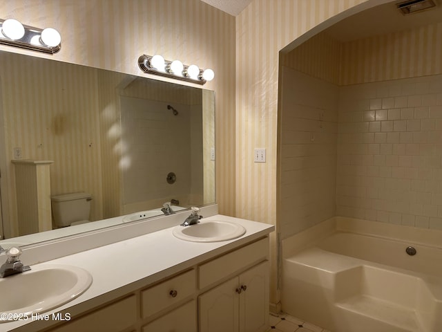 108 Red Oak Dr, Goldsboro, NC 27530 - full bathroom featuring wallpapered walls, toilet, double vanity, and shower / bath combination