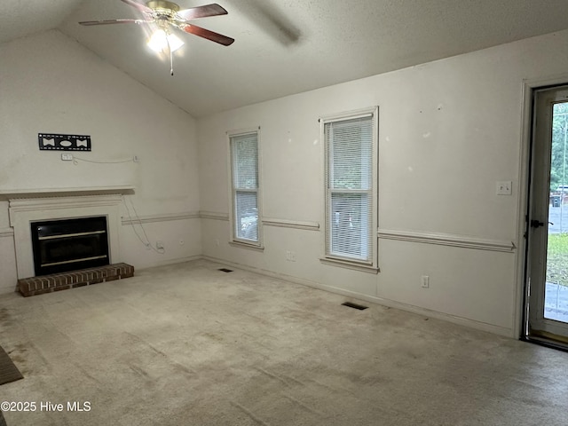 108 Red Oak Dr, Goldsboro, NC 27530 - unfurnished living room with carpet floors, lofted ceiling, a ceiling fan, and a brick fireplace