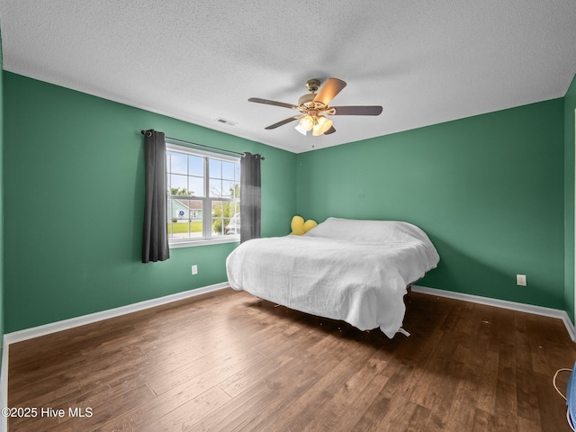 329 Buckhead Rd, Hubert, NC 28539 - bedroom featuring a textured ceiling, wood finished floors, baseboards, and a ceiling fan