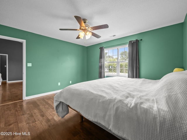 329 Buckhead Rd, Hubert, NC 28539 - bedroom with wood finished floors, baseboards, a ceiling fan, and a textured ceiling