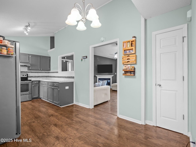 329 Buckhead Rd, Hubert, NC 28539 - kitchen with gray cabinetry, stainless steel appliances, vaulted ceiling, decorative backsplash, and light countertops