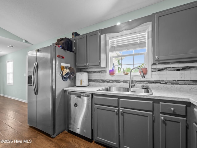 329 Buckhead Rd, Hubert, NC 28539 - kitchen with stainless steel appliances, a sink, gray cabinetry, decorative backsplash, and vaulted ceiling