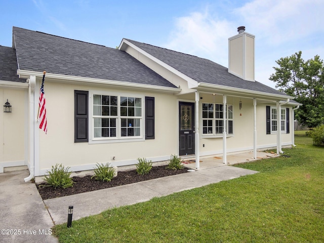 329 Buckhead Rd, Hubert, NC 28539 - ranch-style home with roof with shingles, a front lawn, and a chimney