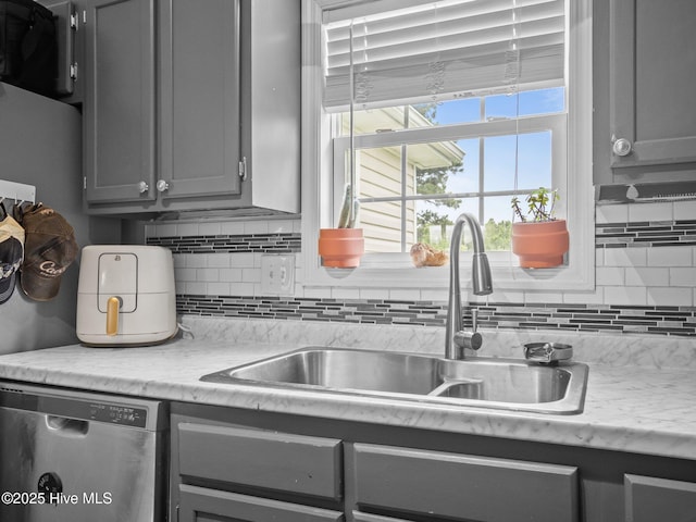 329 Buckhead Rd, Hubert, NC 28539 - kitchen featuring stainless steel dishwasher, gray cabinets, a sink, and tasteful backsplash
