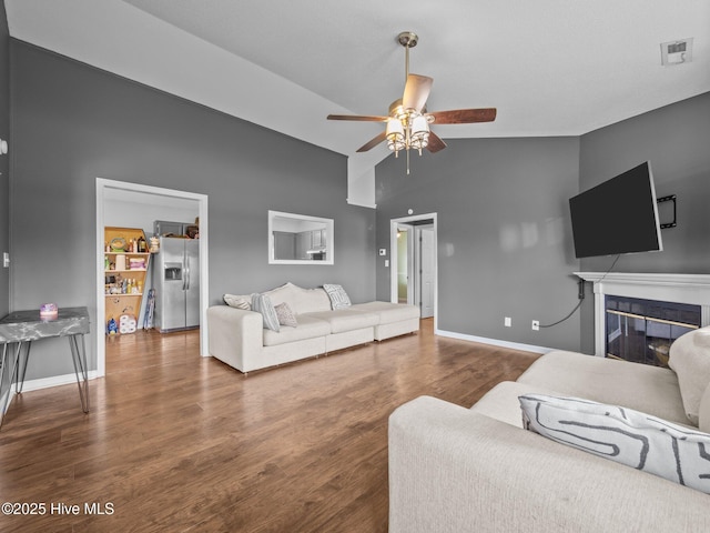 329 Buckhead Rd, Hubert, NC 28539 - living area featuring high vaulted ceiling, ceiling fan, wood finished floors, baseboards, and a glass covered fireplace