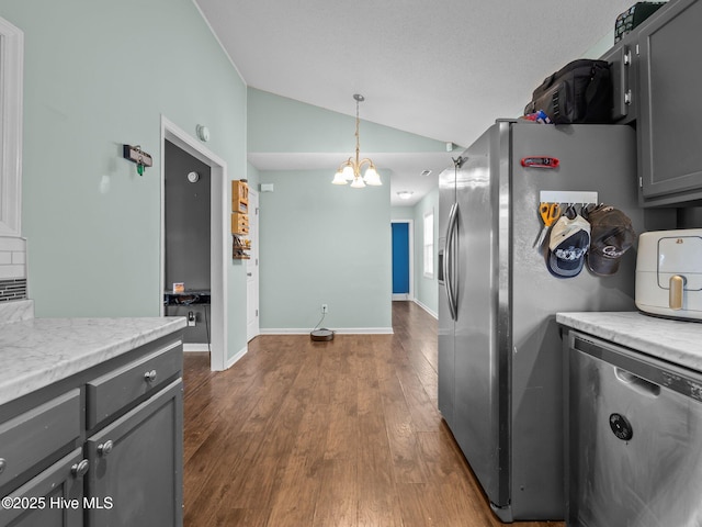 329 Buckhead Rd, Hubert, NC 28539 - kitchen with stainless steel appliances, lofted ceiling, a chandelier, gray cabinetry, and dark wood finished floors