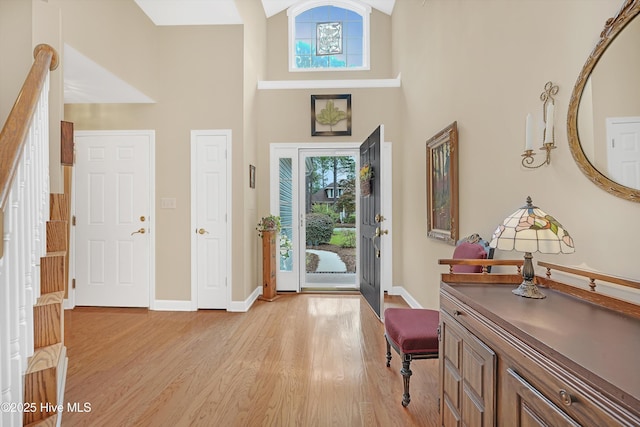 3856 Harmony Cir, Southport, NC 28461 - entrance foyer featuring healthy amount of natural light, light wood-type flooring, a high ceiling, and baseboards