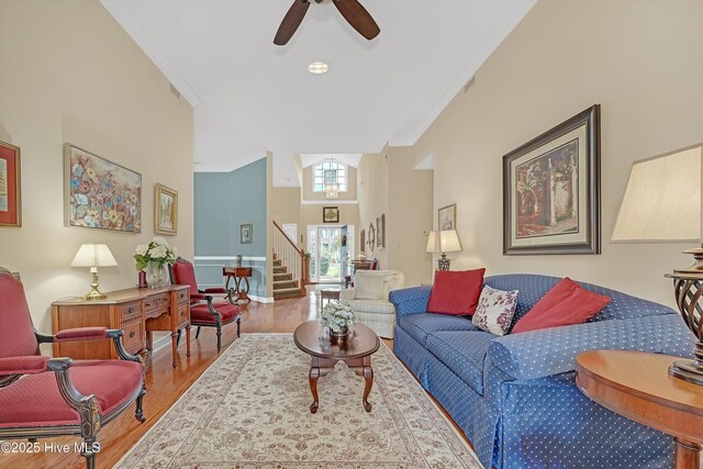 3856 Harmony Cir, Southport, NC 28461 - living area featuring stairs, wood finished floors, ornamental molding, and ceiling fan
