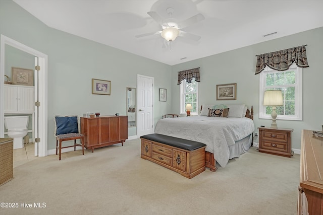 3856 Harmony Cir, Southport, NC 28461 - bedroom featuring connected bathroom, light carpet, baseboards, and ceiling fan