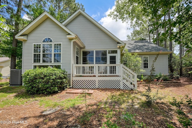 3856 Harmony Cir, Southport, NC 28461 - rear view of property featuring a sunroom and central AC