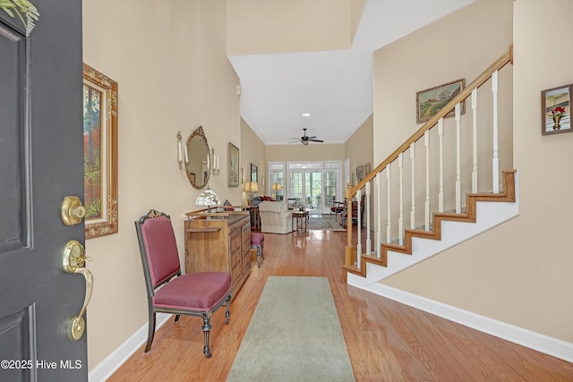 3856 Harmony Cir, Southport, NC 28461 - foyer entrance with wood finished floors, ceiling fan, stairs, and baseboards