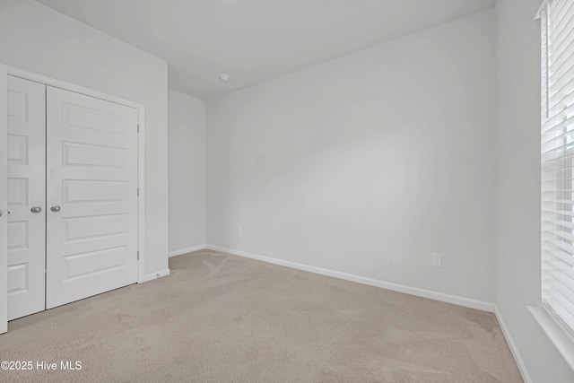 6437 Twinspur Ct SW, Ocean Isle Beach, NC 28469 - unfurnished bedroom with carpet floors, a closet, and multiple windows