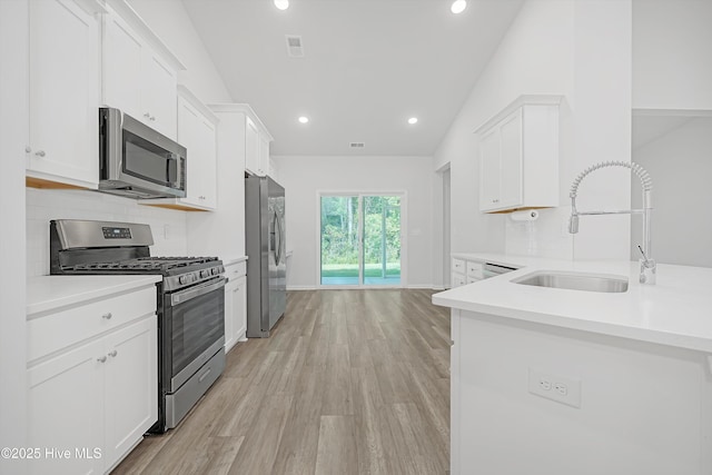 6437 Twinspur Ct SW, Ocean Isle Beach, NC 28469 - kitchen with stainless steel appliances, white cabinetry, tasteful backsplash, recessed lighting, and light countertops
