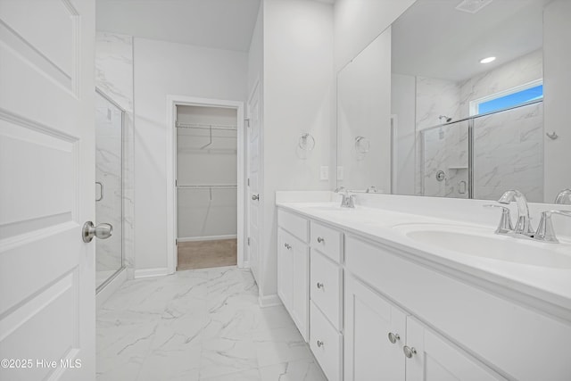 6437 Twinspur Ct SW, Ocean Isle Beach, NC 28469 - bathroom featuring marble look tiles, a marble finish shower, double vanity, and a walk in closet