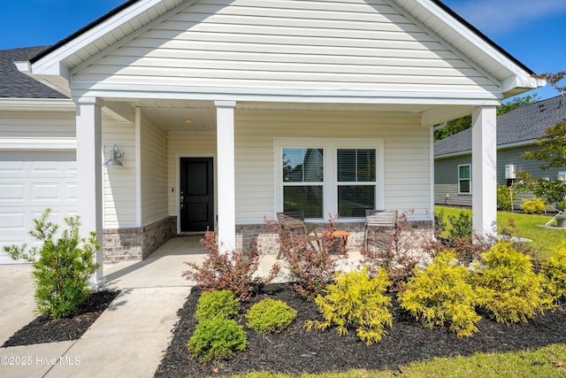 6437 Twinspur Ct SW, Ocean Isle Beach, NC 28469 - doorway to property with covered porch, roof with shingles, an attached garage, and stone siding