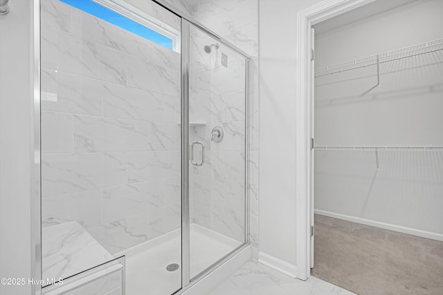 6437 Twinspur Ct SW, Ocean Isle Beach, NC 28469 - full bathroom featuring a stall shower, a spacious closet, and marble look tiles