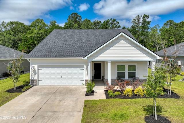 6437 Twinspur Ct SW, Ocean Isle Beach, NC 28469 - view of front of home with a porch, a garage, driveway, a front lawn, and roof with shingles
