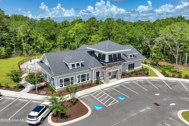 6437 Twinspur Ct SW, Ocean Isle Beach, NC 28469 - view of building exterior featuring uncovered parking and a view of trees