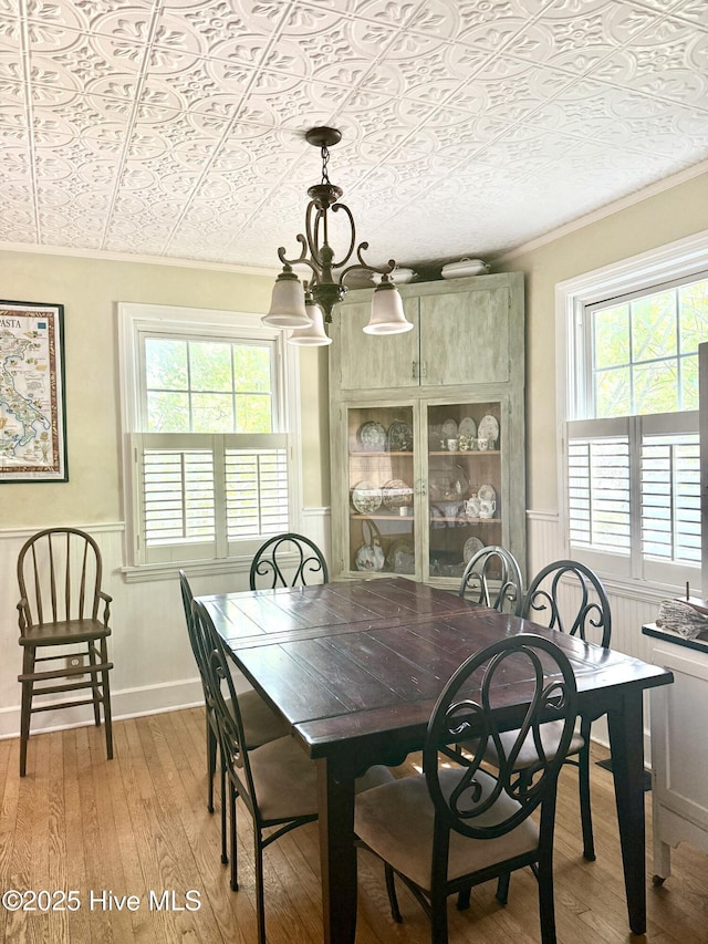 2210 Klein Rd, Wilmington, NC 28405 - dining room with an ornate ceiling, light wood-type flooring, a wainscoted wall, plenty of natural light, and crown molding